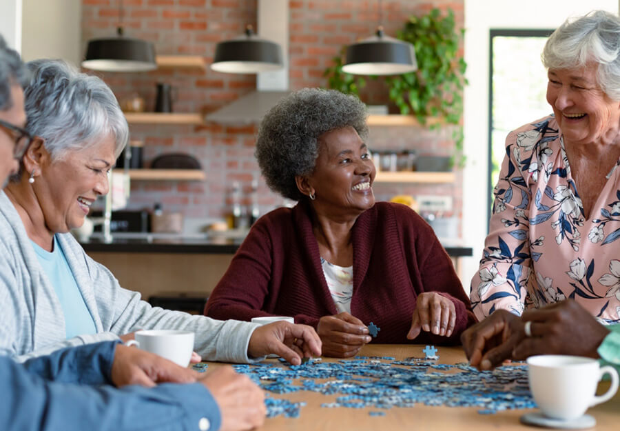 Happy senior friends enjoy a puzzle